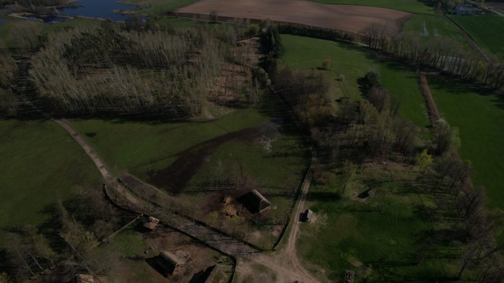 Aerial view showcasing the Biskupin archaeological site, highlighting its historic layout and rural landscape.