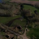 Aerial view showcasing the Biskupin archaeological site, highlighting its historic layout and rural landscape.