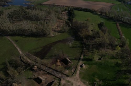 Aerial view showcasing the Biskupin archaeological site, highlighting its historic layout and rural landscape.